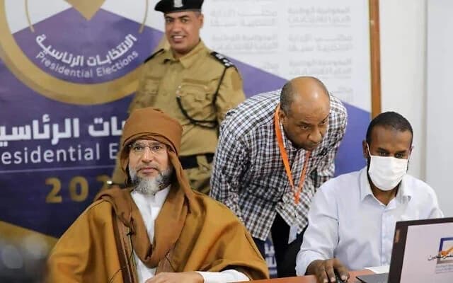 سيف الإسلام القذافي، على اليسار، يسجل ترشحه للانتخابات الرئاسية في سبها، ليبيا، 14 نوفمبر 2021. (المفوضية الوطنية العليا للانتخابات الليبية عبر وكالة أسوشيتد برس)